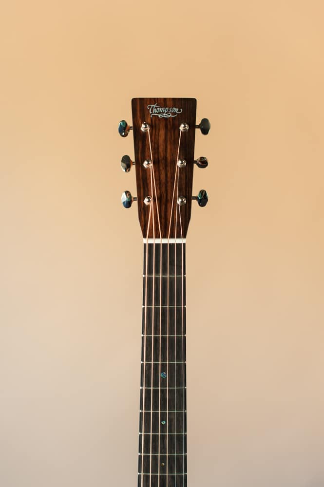 Acoustic dreadnought guitar handcrafted of mahogany back and sides with an adirondack top. Headstock front