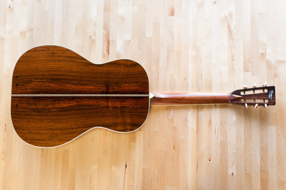 12 Fret 000 acoustic guitar handcrafted from Adirondack Spruce and Brazilian Rosewood. Back wood